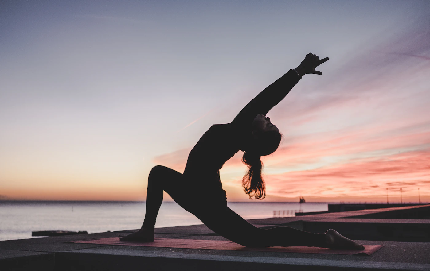 Pregnant woman practising gentle yoga — illustrative image